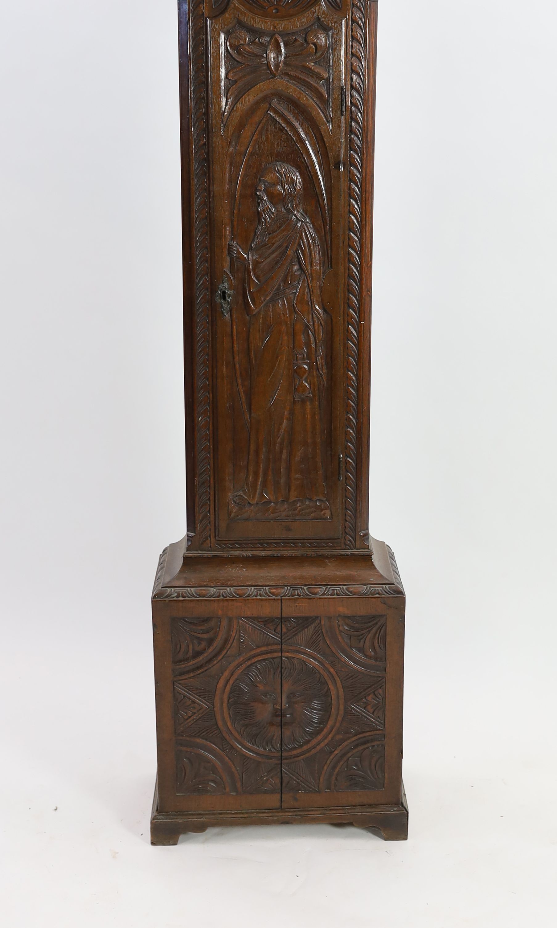 A George III oak eight day longcase clock, the 30cm arched dial marked Arlot, Sunderland, with subsidiary seconds and calendar dials, case 250cm high (later carved)